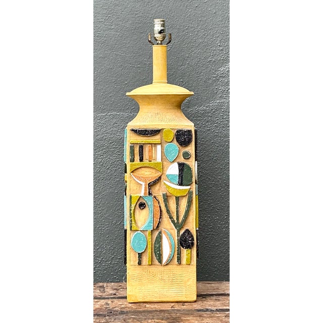 This vintage mid-century modern table lamp features a bold, square ceramic base entirely covered in a mosaic-like...