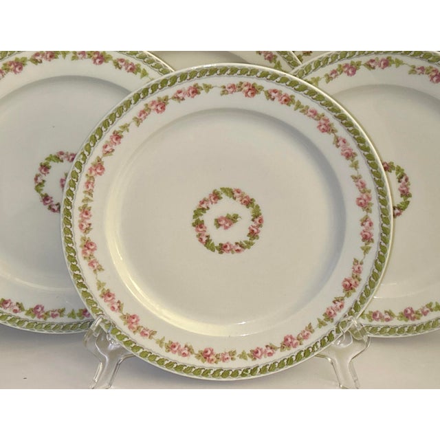 Six (6) French Limoges M Roden Antique Plates. Floral pink rose trimmed banner with floral center. Excellent condition....