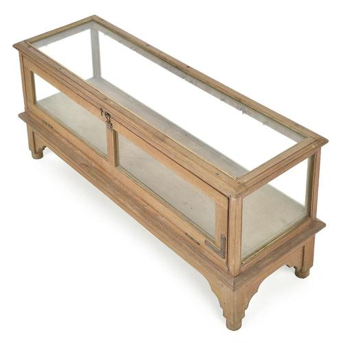 This antique display cabinet seduces with its sober and functional look, combining wooden structure and glass panels on...