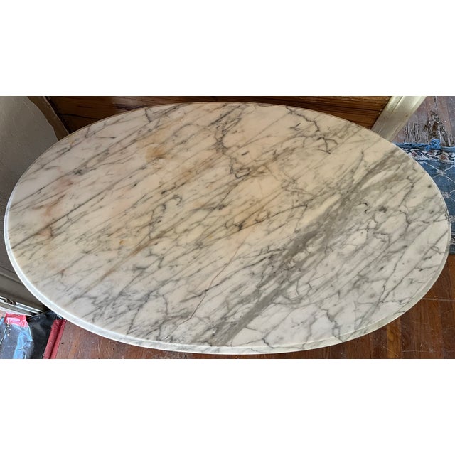 A French Provincial style oval center table with a genuine Italian marble top — the marble is stamped "ITALY" on the...