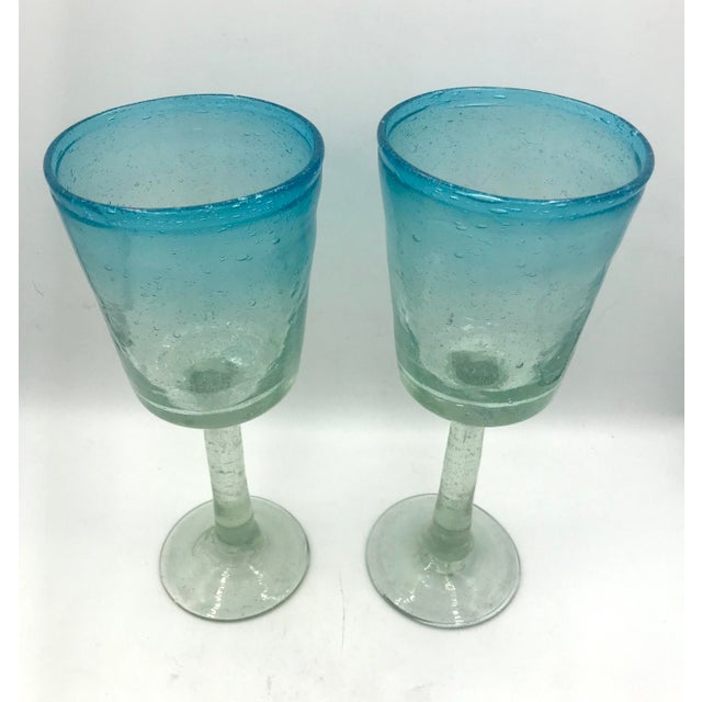 Hand blown tall wine glasses or goblets in a stunning Aqua ombre. The glass is filled with natural small bubbles and there...