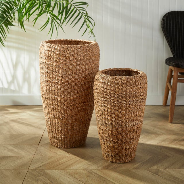 This set of tall seagrass planters are tightly woven around a wire metal frame. This warm, natural look in an overscaled...
