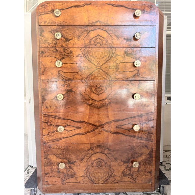Striking Art Deco piece. Rosewood matchbook front with walnut top, sides and drawers. Bottom drawer is cedar lined. Button...