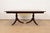 An exceptional Georgian or Regency style double pedestal extension dining table In the manner of Baker Furniture USA,...