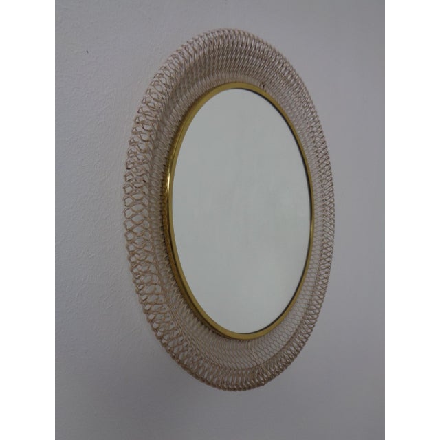 French mirror in white lacquered woven metal from the 1960s. Border of the mirror in brass.