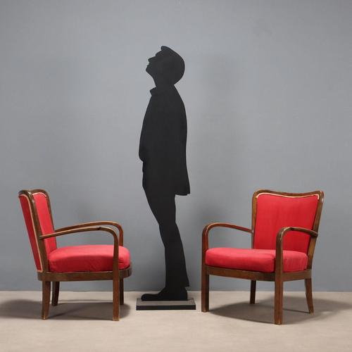 Pair of armchairs with a frame made of stained beech wood, metal straps, sprung seat cushions and fabric upholstery. This...