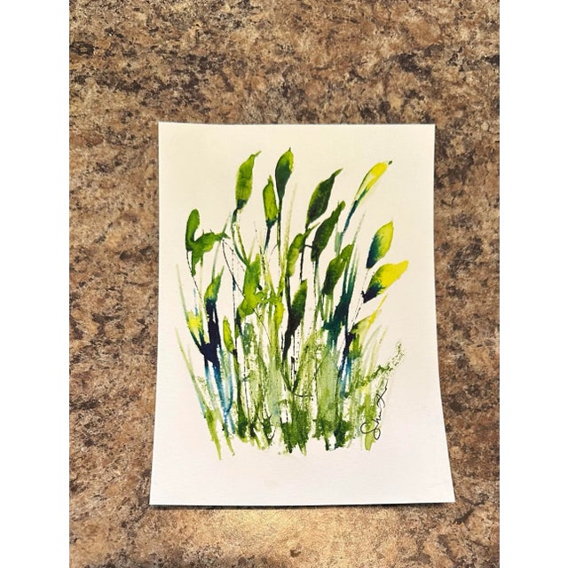 A lively cluster of vibrant green and yellow leaves rising upward, capturing the energy of spring’s renewal.