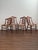 This set of four antique dining chairs dates to the late Victorian period and reflects a European-influenced approach to...