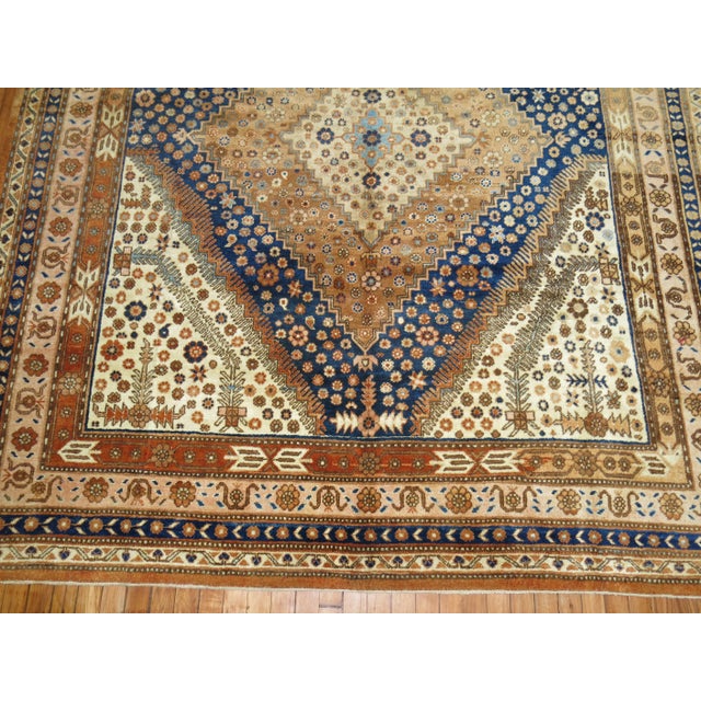Large Gallery Size Khotan rug from the middle of the century with a geometric design in deep blue, burnt orange, and...