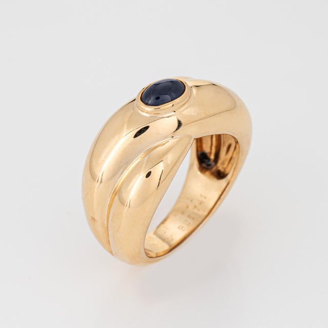 Vintage Cartier Colisee sapphire ring crafted in 18k yellow gold (circa 1992). Cabochon cut sapphire measures 05mm x...