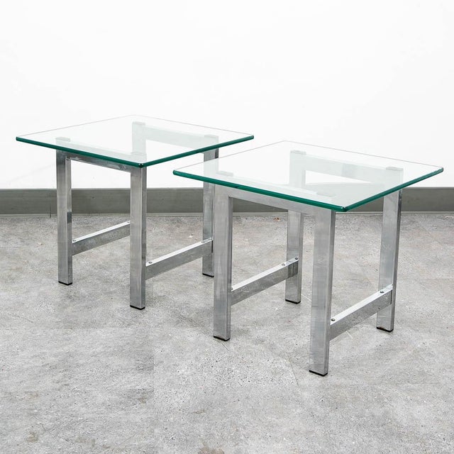Pair of polished chrome end tables with square glass tabletops. High quality and well designed. Unmarked examples.