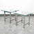 Pair of polished chrome end tables with square glass tabletops. High quality and well designed. Unmarked examples.