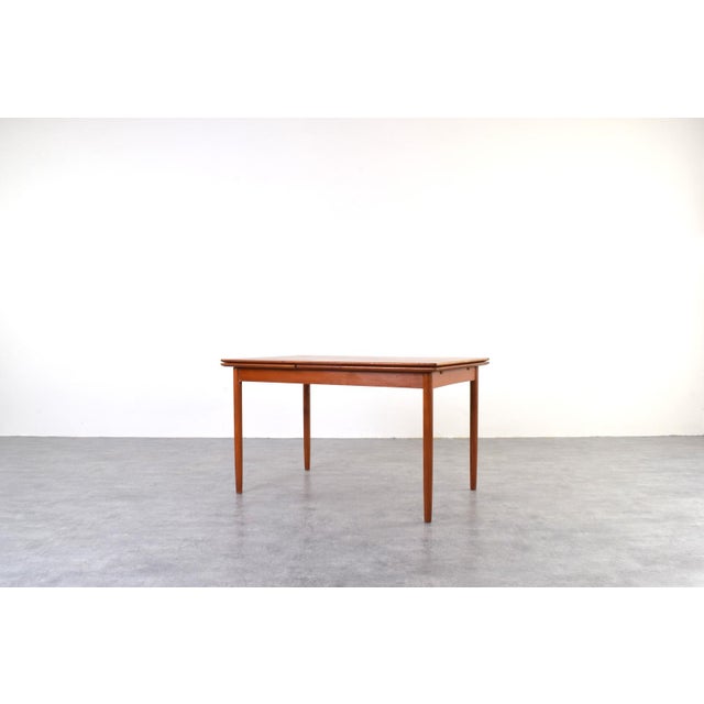 This teak table was manufactured in Denmark in the 1960s. It is in good, original condition with signs of wear, including...