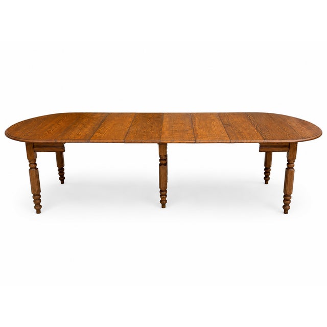 This antique solid oak extension dining table is a beautiful example of classic American craftsmanship, offering both...