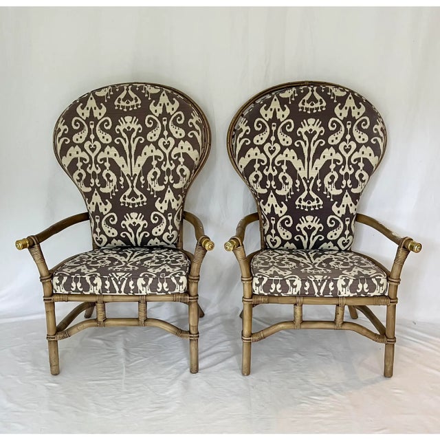 Vintage pair of Ficks Reed fan back rattan chairs. Woven high "peacock" style backs with curved arms capped in brass. Come...