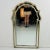 An Italian Regency style parclose wall mirror, unbranded. Mirrored glass in a solid wood frame painted gold. Features...
