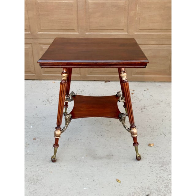 A beautiful addition to any antique lovers home. Late 19th - early 20th century center table with brass Foo Dogs for shelf...