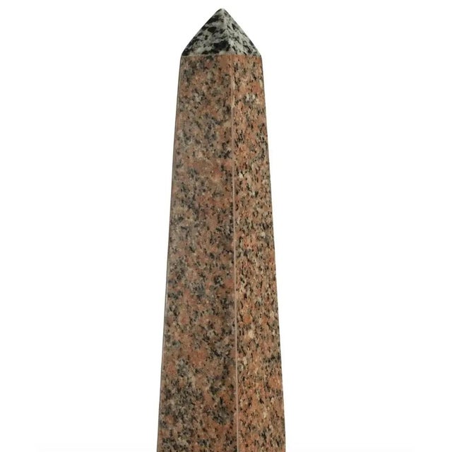 A stunning pair of monumental neoclassical or Grand Tour style solid marble pink, gray, brown, and black obelisks on solid...