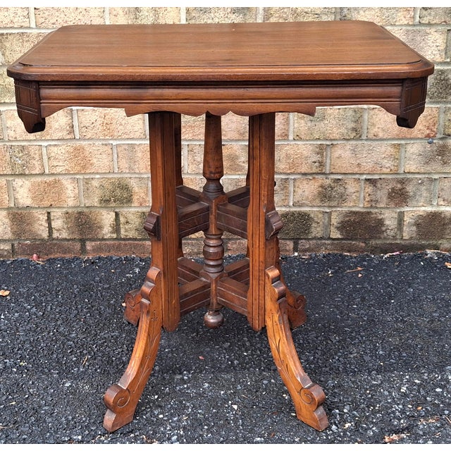 A late 19th Century Victorian Eastlake Style Carved Walnut Side Table Measures 28" in width, 20" in depth and 29" in height.