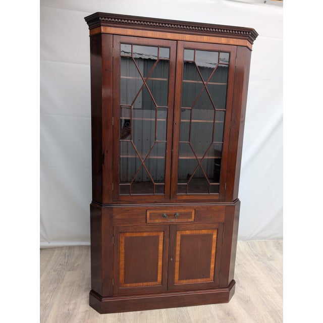Corner Display Cabinet in English Walnut This English-style corner display cabinet is finished with mahogany veneer. The...