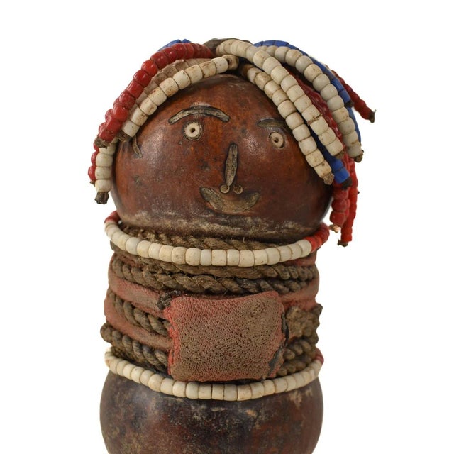 The Nyamwezi Beaded Fertility Doll Gourd from Tanzania is a stunning representation of fertility and tradition, crafted by...