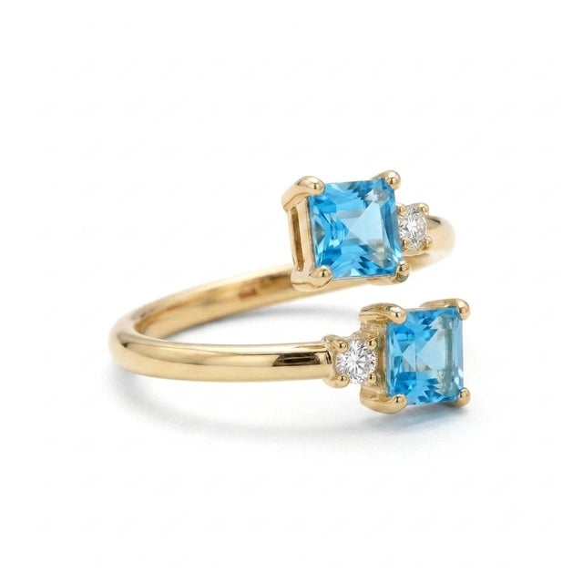 Add a modern touch of elegance to your jewelry collection with this stunning open wrap ring featuring two vibrant 4x4mm...