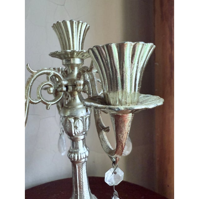 Vintage mid century five arm candelabra with ornate Rococo and Victorian style design. Silver tone metal with scrolled...