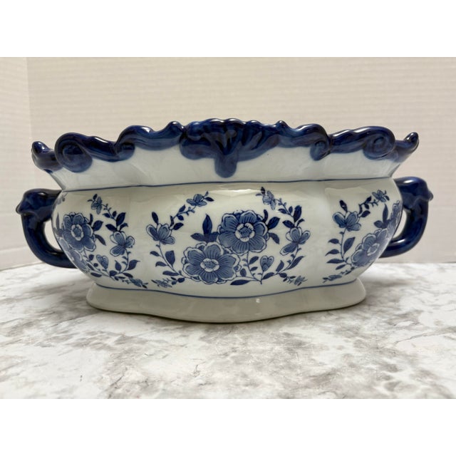 Classic country cottage blue and white pottery ceramic floral plant vessel with curvy side accent handles and design....