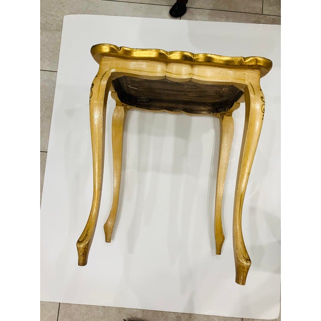 This wood table is painted ivory with gold leaf floral accents on top 14 x 17 x 20 h nice accent table size