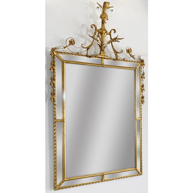 Vintage Neoclassical Regency style wall mirror with beveled glass frames. Features clam shell atop urn with intricate...