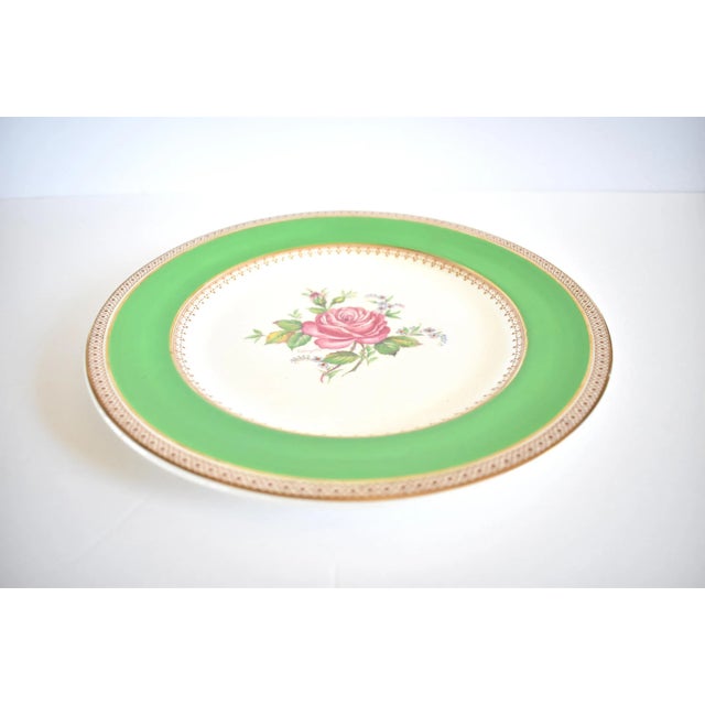 A vintage, Wedgwood of Etruria "Tudor Rose" 10" dinner plate, with a central rose design and a border of kelly green and...