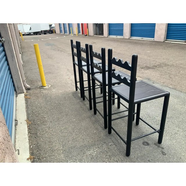 country French solid oak counter stools. Stools are done in a rich satin/ebony finish. . The stools were custom made. The...