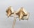 1960s textured goldtone in the shape of a leaf with two ellipsoid mother of pearl beads the top butterfly clip back...