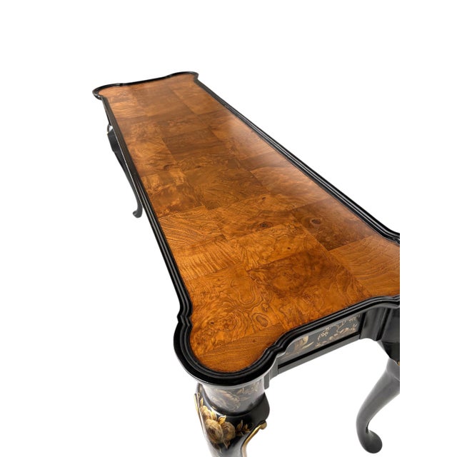 A fine Console or Sofa Table in black lacquer with a chinoiserie frame decorated in shades of gold. Designs of trees,...