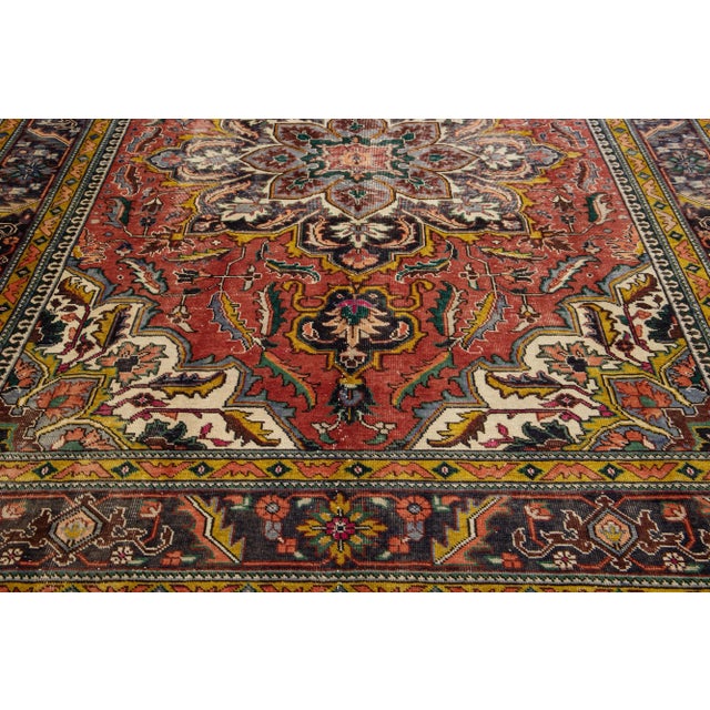 Beautiful vintage Persian Heriz hand-knotted wool rug with a navy blue color field. This rug has a black frame and...