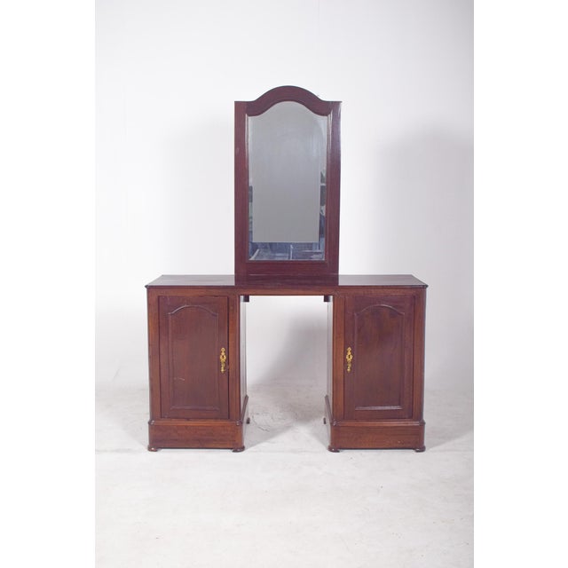 Dressing table with mirror. Two lower doors with decorated metal handles provide discreet and functional storage space,...
