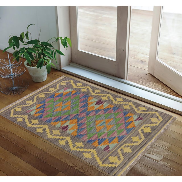 Elevate your home decor with this stunning Tribal Kilim wool rug, hand-woven by the Nomad Turkman people on a loom. Made...