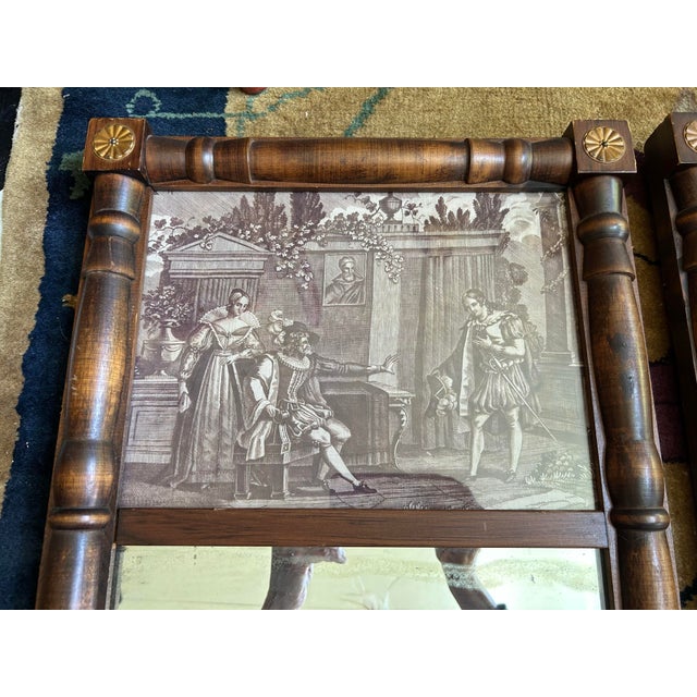 A pair of antique mirrors accented with antique toile