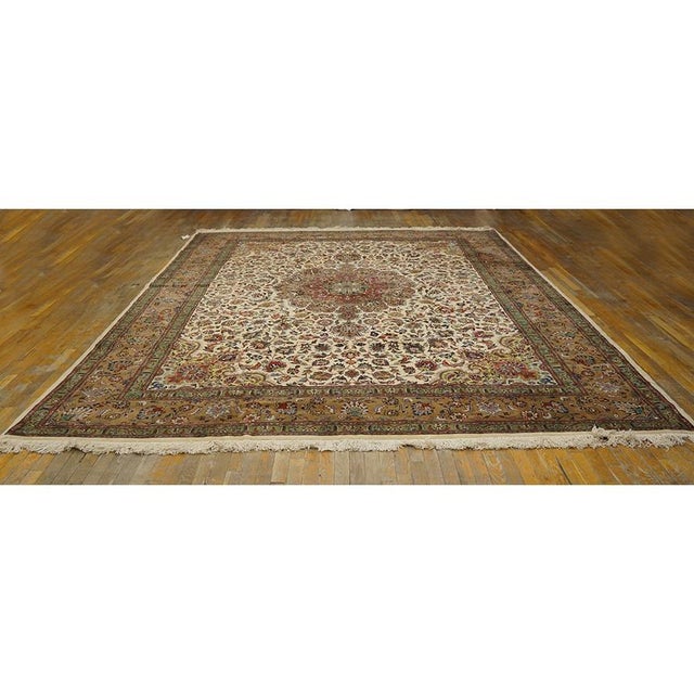This is a sophisticated circa-1940s antique Tabriz rug from Iran, measuring 9' 10" x 13' 3". Featuring a classic formal...