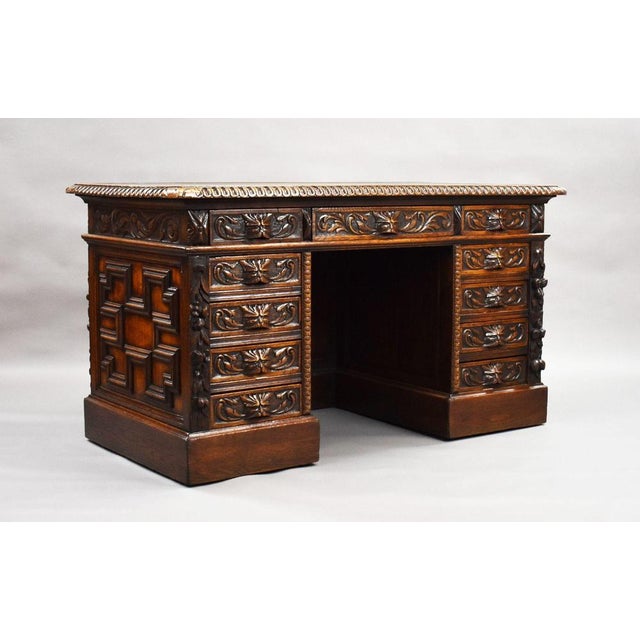 Victorian Carved Oak Pedestal Desk with Green Leather Top A substantial and highly decorative Victorian carved oak...