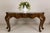 This substantial Marge Carson console table showcases the dramatic curves and elegant proportions that helped establish...