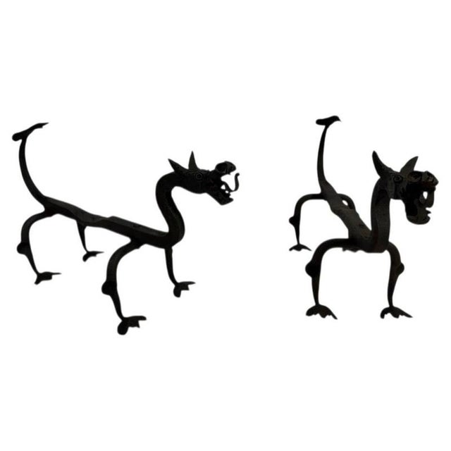 This beautiful and unusual pair of andirons depicting dragons is made of wrought iron. They are of French origin. Circa 1940