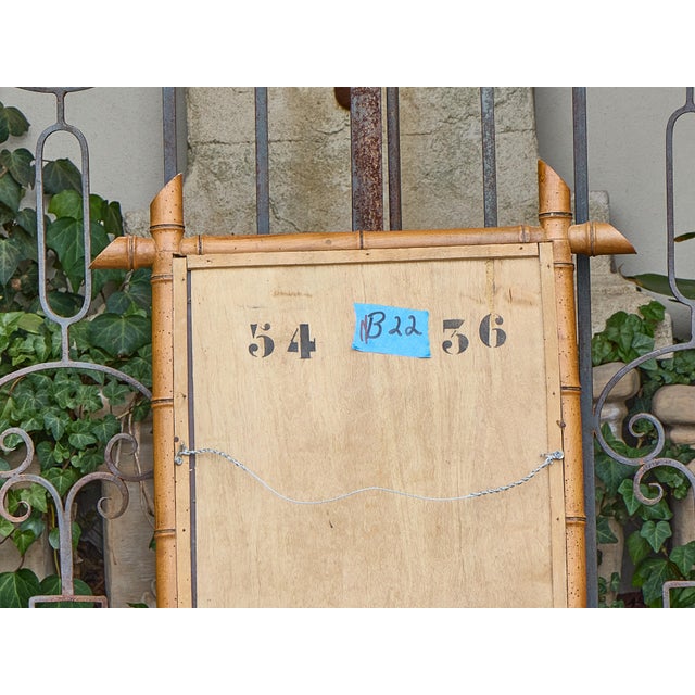 Crafted in France circa 1900, this charming rectangular mirror is designed in the faux bamboo style, evoking the exotic...