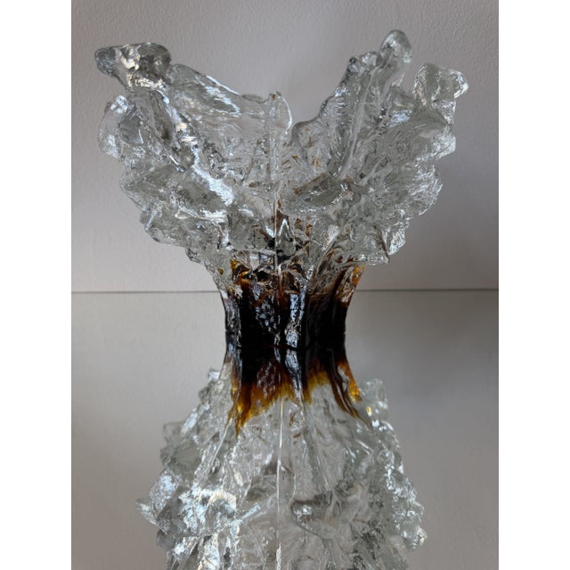 A sculptural ice glass vase in the Finnish tradition of the 1970s, built in two layers: a core of deep amber-brown glass,...
