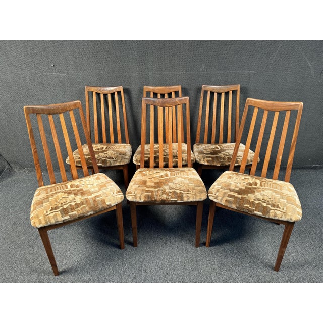 Made in the UK by G-Plan. These MCM dining chairs feature gorgeous wood grain frames, sculpted backs and comfortable...