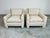 A pair of Mid-Century Modern club chairs in the manner of Milo Baughman having parsons style frames with neutral tweed...