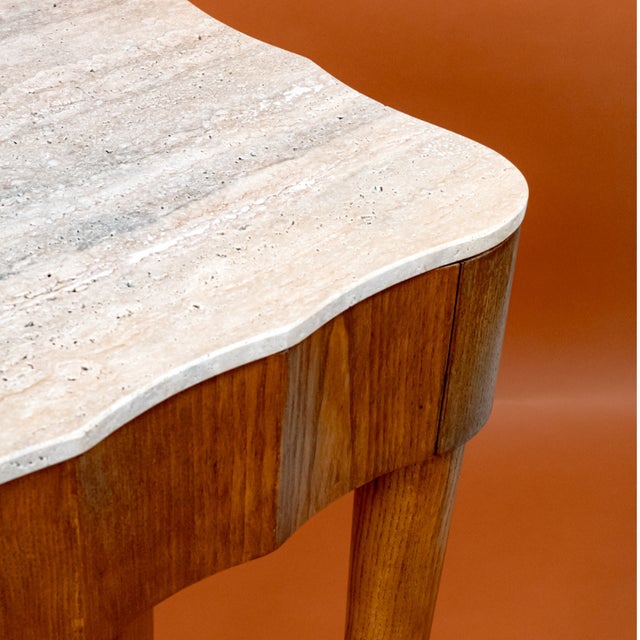 Italian Mid-Century console table with an ash wood base and travertine marble top. It features two drawers for storage....