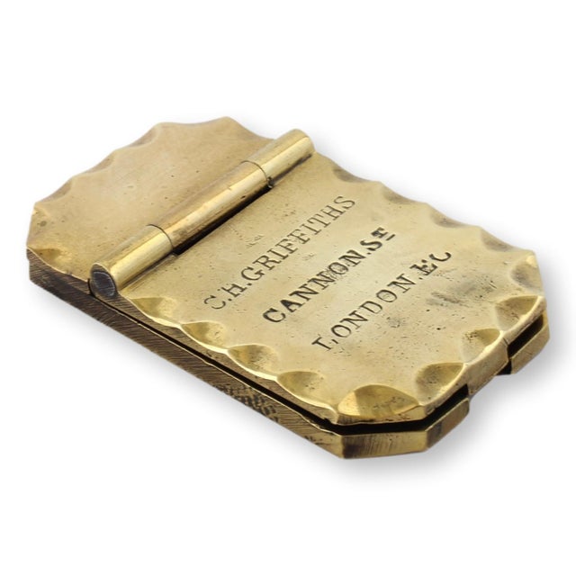 Antique brass lock cover engraved with "C.H. Griffiths, Cannon St, London E.C." This finely crafted piece likely served as...