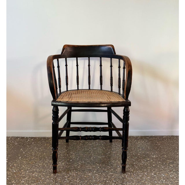 Beautiful, antique wooden chair, organically downward curved arms and nine turned spindles in its backrest. Wonderful...