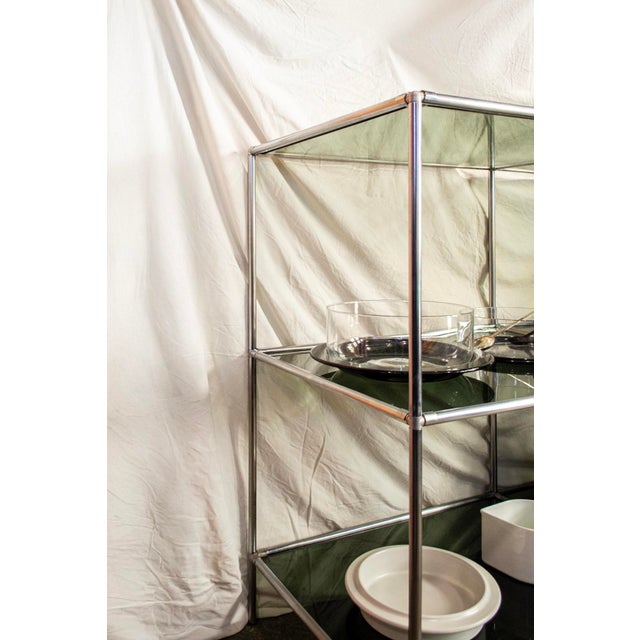 Freestanding modular shelving unit or room divider with a steel frame and glass shelves. Model: Abstracta Designer: Poul...
